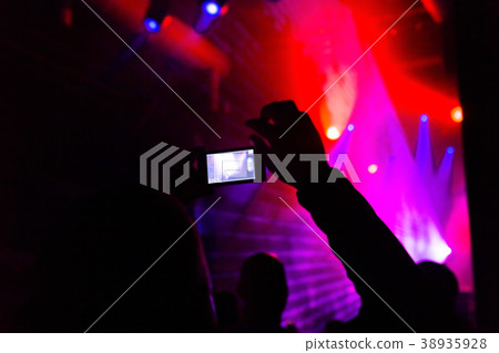 Man taking photo mobile phone of silhouettes crowd Man taking photo mobile phone of silhouettes crowd 38935928