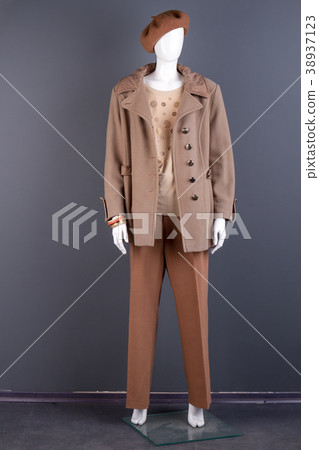 Women stylish beige top coat on mannequin. 38937123