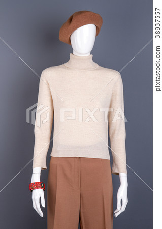 White sweater and brown trousers on mannequin. White sweater and brown trousers on mannequin. 38937557