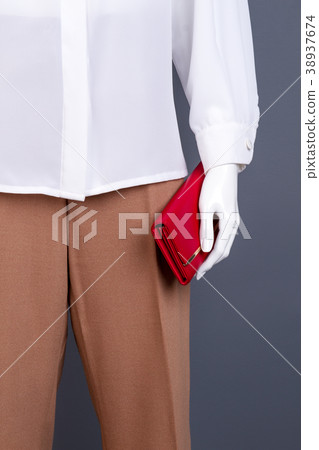 Female mannequin with red leather purse. Female mannequin with red leather purse. 38937674