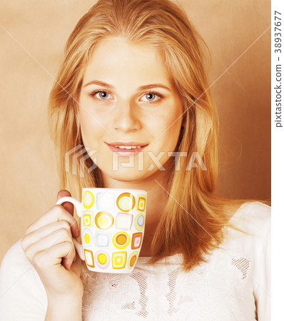 young cute blond girl drinking coffee close up on young cute blond girl drinking coffee close up on 38937677