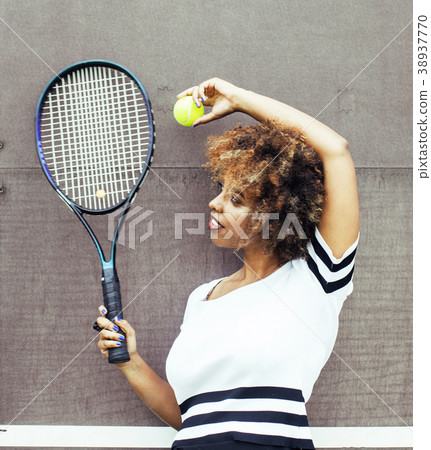 young stylish afro-american girl playing tennis 38937770