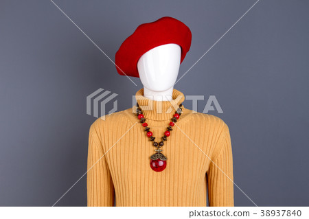 Yellow sweater and red necklace on mannequin. Yellow sweater and red necklace on mannequin. 38937840