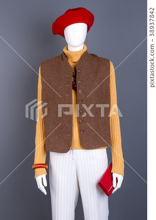 Red beret, waistcoat on female mannequin. Red beret, waistcoat on female mannequin. 38937842