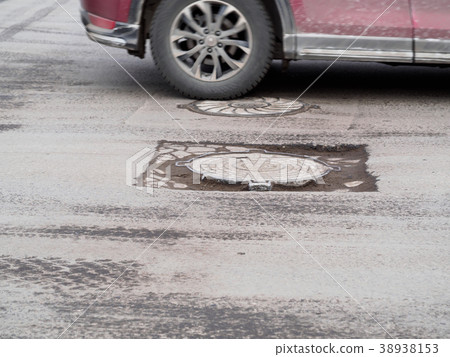 damaged asphalt on the road 38938153