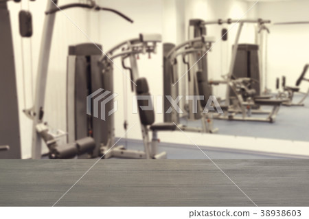 Blur fitness gym background and wooden desk space 38938603