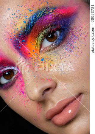 Face with bright multicolored fashion makeup Face with bright multicolored fashion makeup 38938721