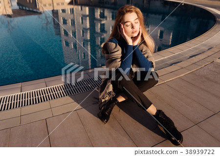 girl in a blue sweater sits by the pool girl in a blue sweater sits by the pool 38939722