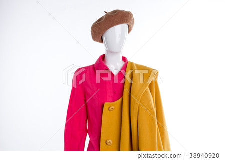 Red blouse and yellow coat on mannequin. 38940920