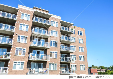 Modern condo buildings with huge windows and balco 38944099
