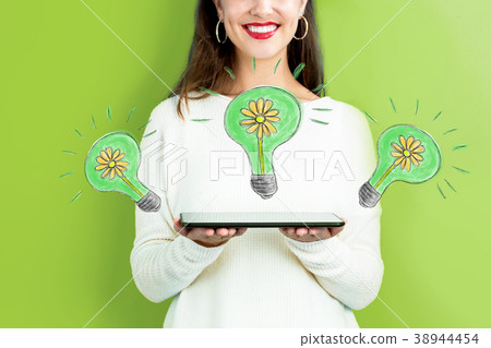 Eco Energy with woman holding a tablet Eco Energy with woman holding a tablet 38944454