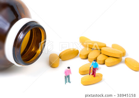 Miniature small figure old man or patient on pill Miniature small figure old man or patient on pill 38945158