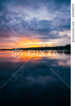 Sunset over a river with an orange sky on horizon 38946644