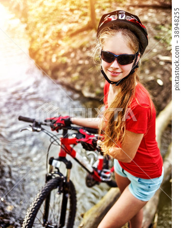 Bicycle teen with ladies bikes in summer park 38948255