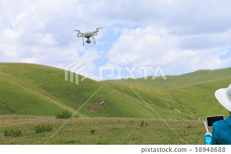 woman photographer flying drone outdoors 38948688