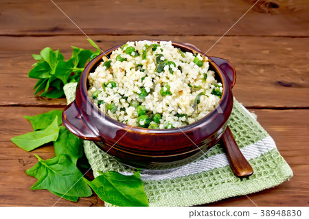 Couscous with spinach and green peas in bowl 38948830