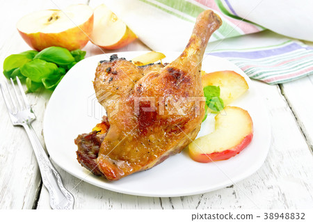 Duck leg with apple on light board 38948832
