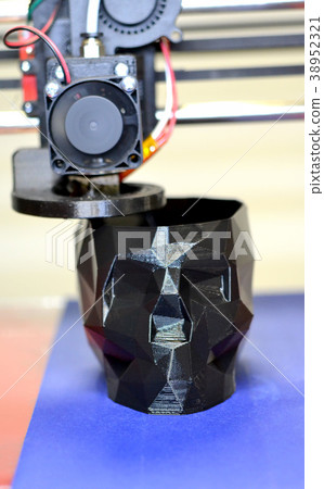 3D printer printing a model in the form of black 3D printer printing a model in the form of black 38952321