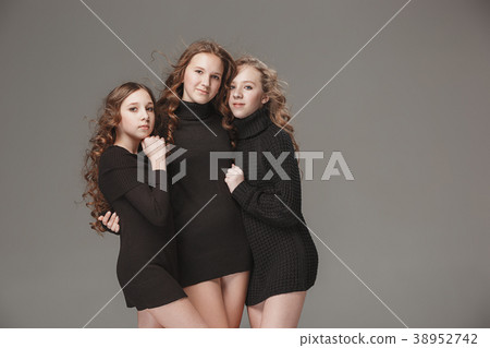 The fashion girls standing together and looking at The fashion girls standing together and looking at 38952742