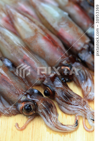 Raw firefly squid on a cutting board 38953369