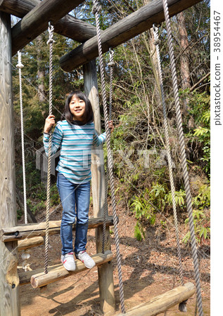 Girls playing with park play equipment 38954467