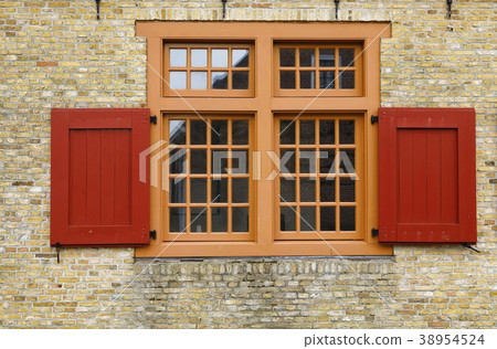 old red wooden window on brock wall 38954524