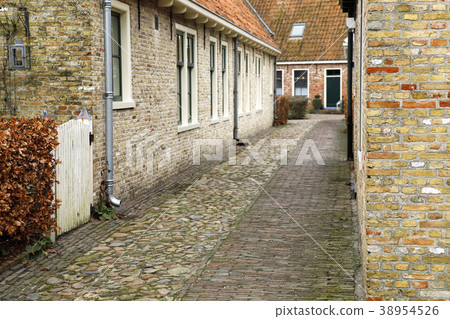 narrow street in very old stone town 38954526