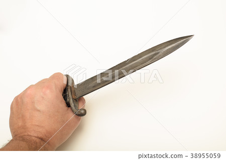 Hand holding old bayonet in close up view Hand holding old bayonet in close up view 38955059