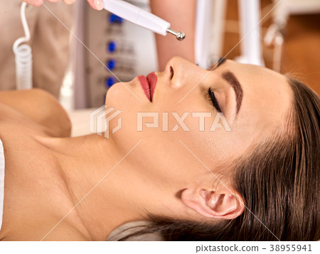Facial massage at beauty salon. Electric Facial massage at beauty salon. Electric 38955941