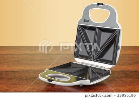 Opened sandwich maker on the wooden table 38956190