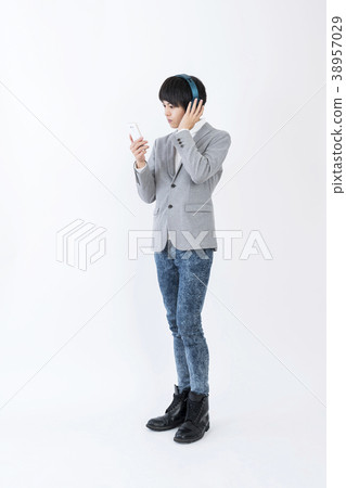 Young man listening to music with headphones 38957029