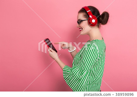 Businesswoman with phone and earphones Businesswoman with phone and earphones 38959896