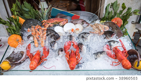 Seafood on ice at the fish market. 38960503