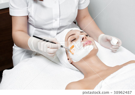 beautician applies mask to the face of  woman  38962487