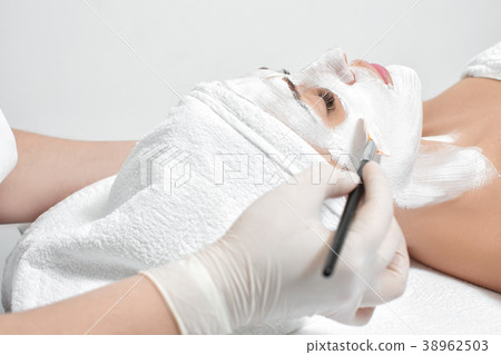 beautician applies mask to the face of  woman  38962503