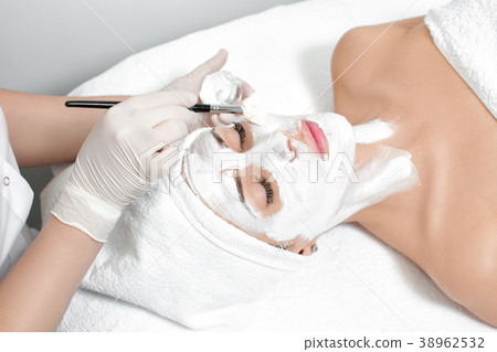 beautician applies mask to the face of  woman  38962532