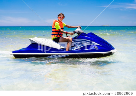 Teenager on jet ski. Teen age boy water skiing. Teenager on jet ski. Teen age boy water skiing. 38962909