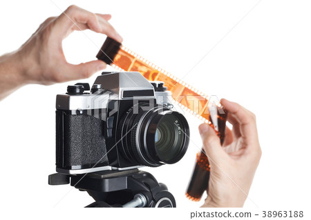 Hands with color negative near SLR camera isolated Hands with color negative near SLR camera isolated 38963188