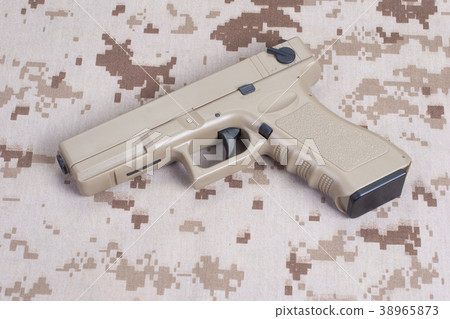 handgun on camouflage uniform handgun on camouflage uniform 38965873