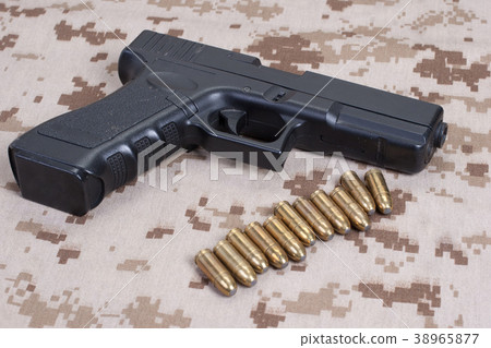 handgun on camouflage uniform handgun on camouflage uniform 38965877