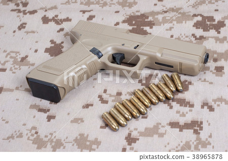 handgun on camouflage uniform 38965878