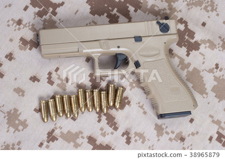 handgun on camouflage uniform 38965879