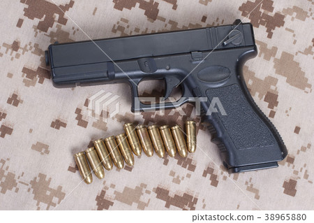 handgun on camouflage uniform 38965880