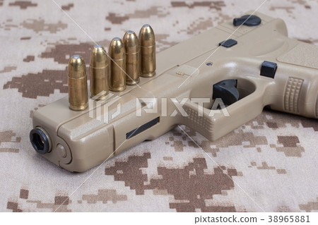 handgun on camouflage uniform handgun on camouflage uniform 38965881