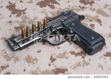 Beretta hand gun on  desert marines uniform 38965905