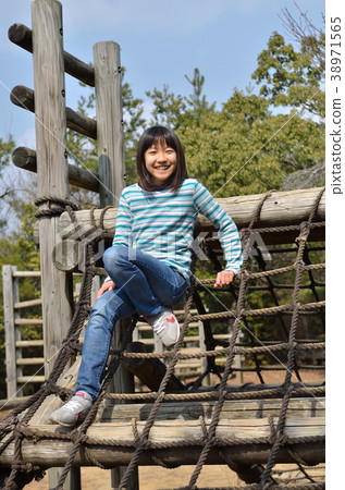 Girls playing with park play equipment 38971565