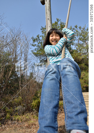 Girls playing with park play equipment 38971566
