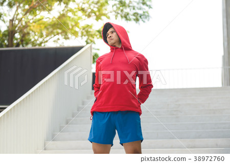 Sport man in red hood warm up his body  38972760