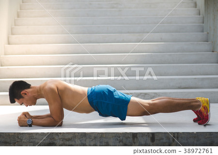 Strong boxer push up on stairs in city outdoor. 38972761