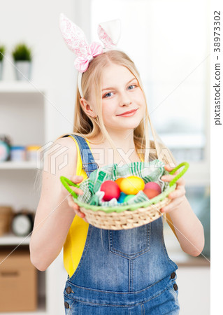 Teenage girl holding Easter eggs 38973302